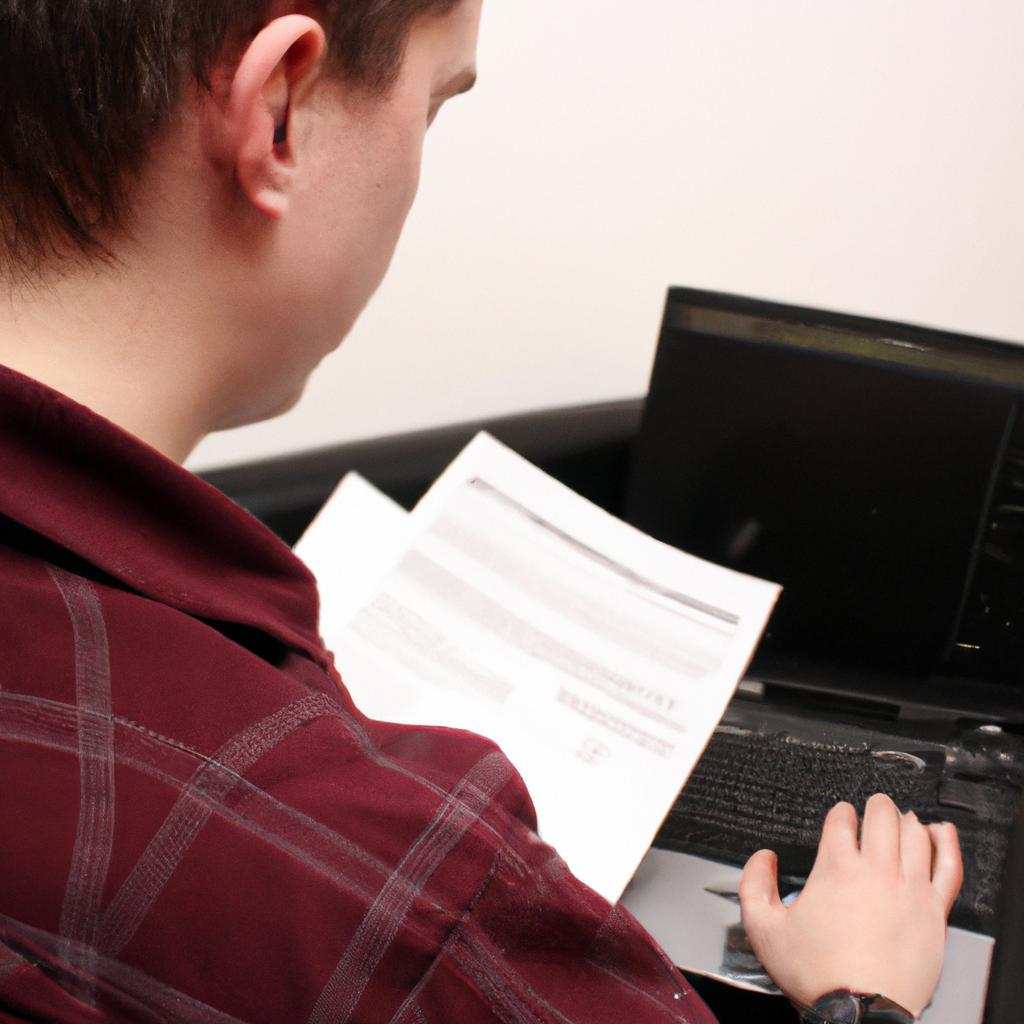 Person reviewing documents on computer